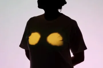 Silhouette of a person with chest highlighted in yellow light