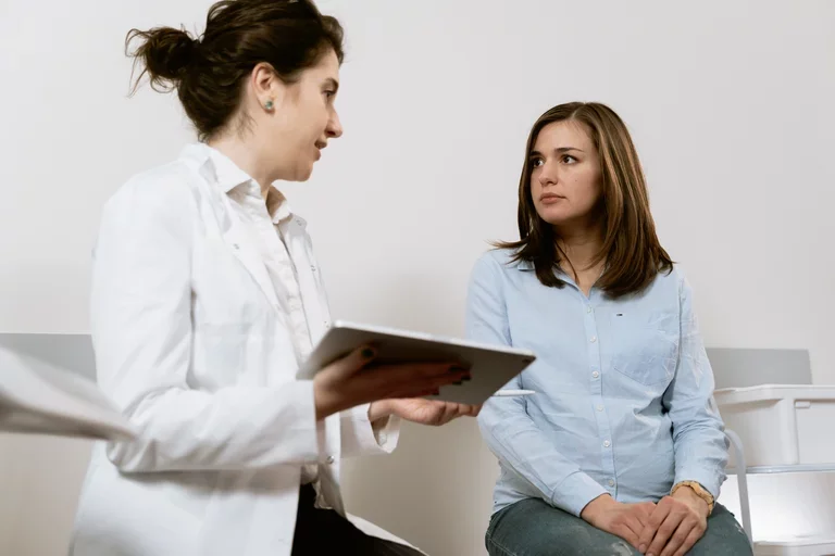 A doctor and patient sit together, reviewing test results.