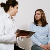 A doctor and patient sit together, reviewing test results.